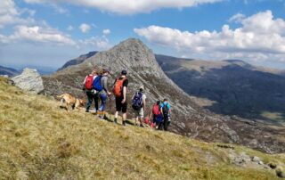 Approaching Tryfan Walkers heading up the rocky shoulder of Tryfan