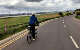 Bristol to Swansea cycling trip Cyclist riding a quiet country road on the Bristol to Swansea cycle trip