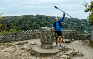 Runner at the Symonds Yat Rock trig point during the Forest of Dean Ultra