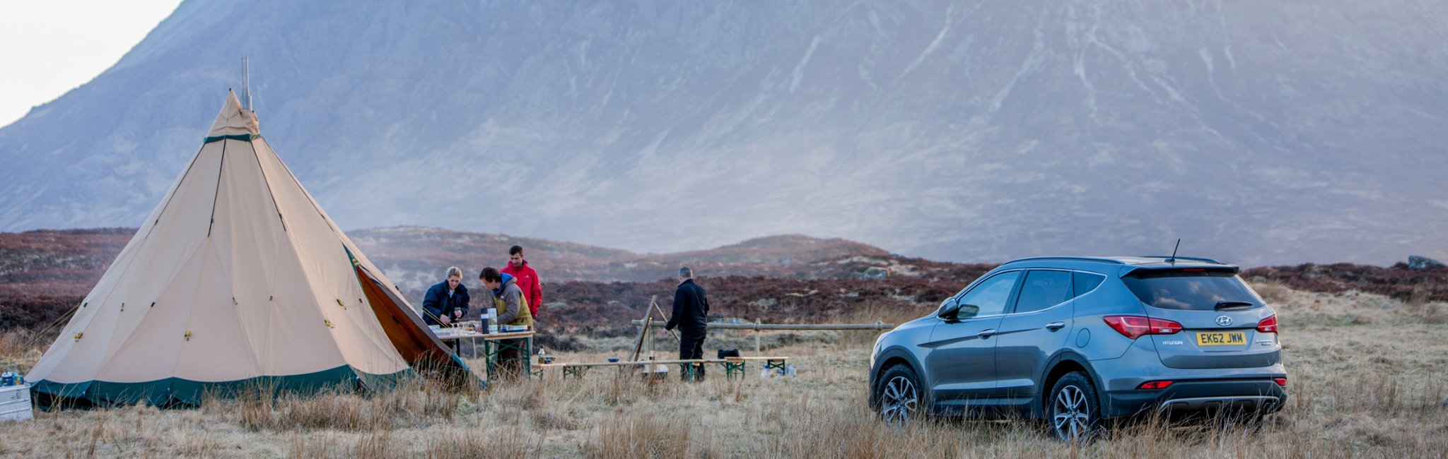Event crew setting up a checkpoint on open moorland beside a 4x4 support vehicle