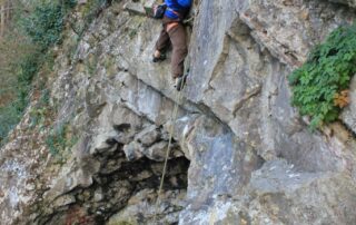 Climber on a new route up a tall limestone face in the Avon Gorge