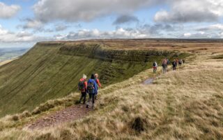 Walkers along a Brecon Beacons escarpment