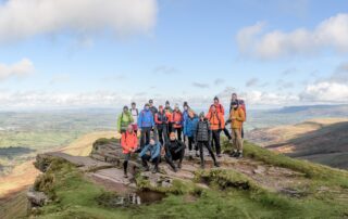 Team on a summit edge in the Brecon Beacons