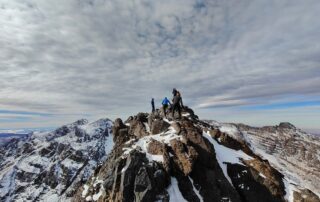 Climbers on a snowy summit ridge above the High Atlas