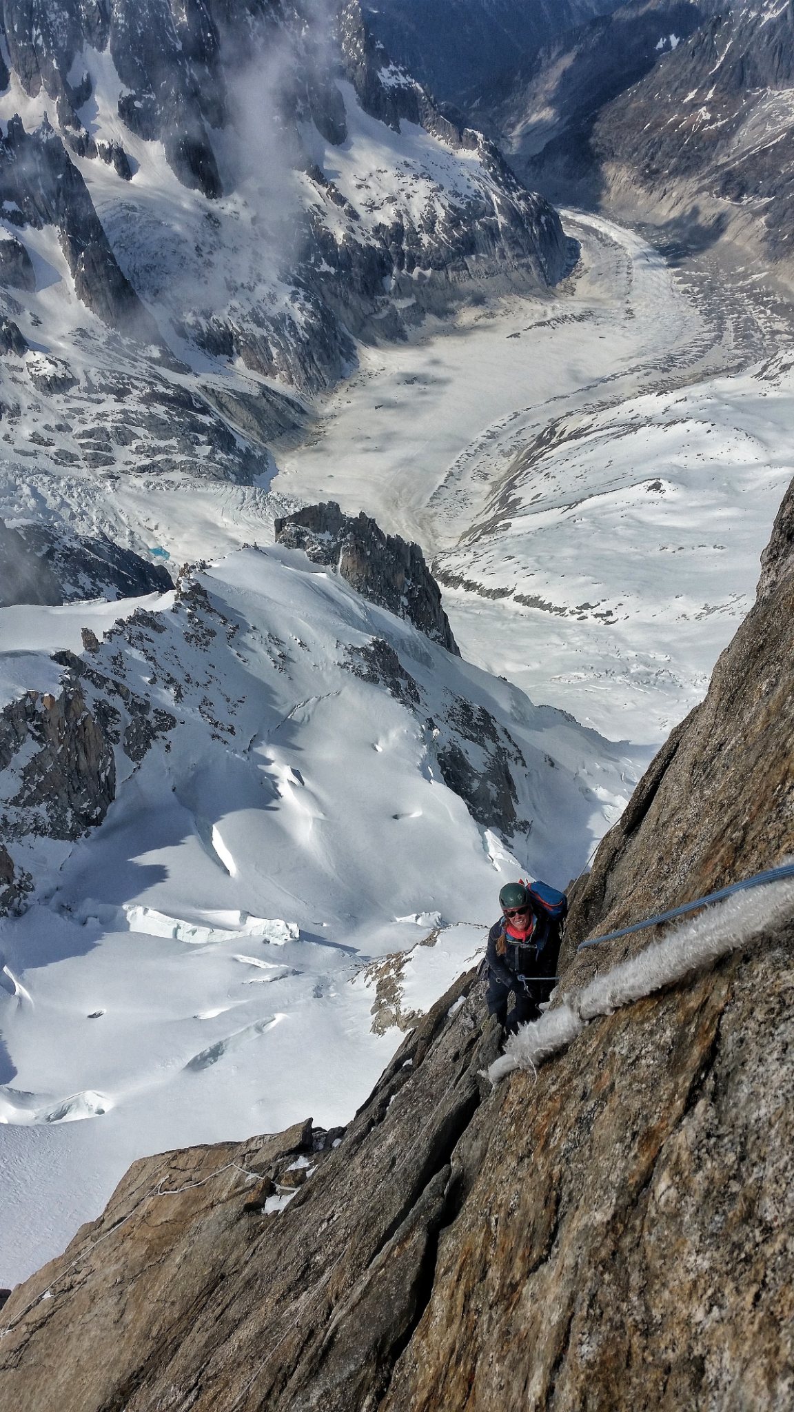 Dave Talbot high on a rocky alpine summit above a glacier
