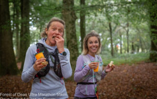 Two runners eating snacks at a Forest of Dean Ultra aid station
